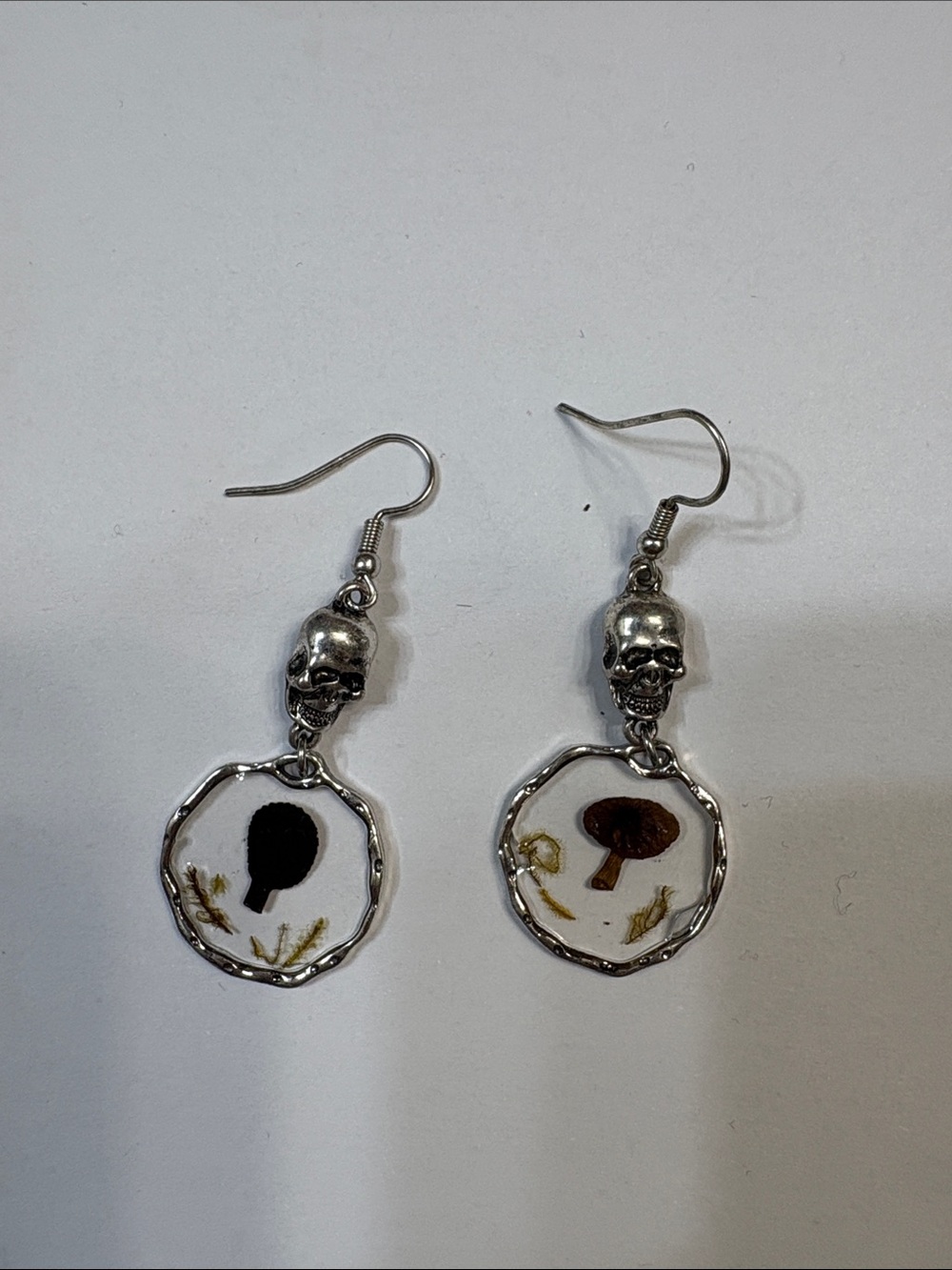 Spencer's Silver Skull Earrings with White, Black, and Brown Mushroom Charms